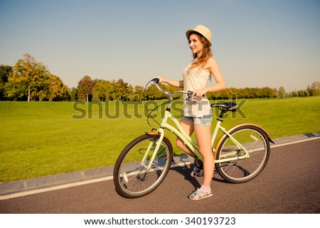 happy cute girl with bike walking on park