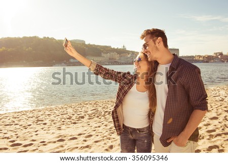Couple in love making selfie photo at the seaside