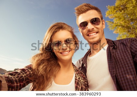 Happy couple in love in glasses making selfie