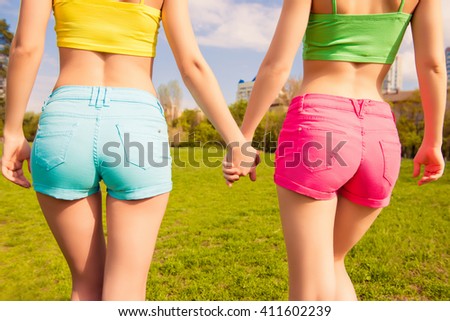 Close up photo of shapely woman's buttocks in color shorts