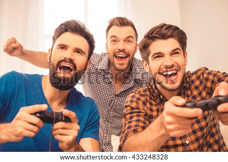 Yeah! close up photo of excited happy cheerful men play video game