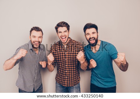 YEAH! three  handsome screaming men showing their strong hands