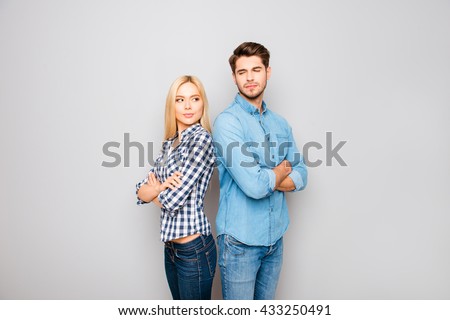 Young angry couple in love standing back to back