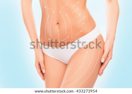 Close up photo of woman touching her  hip with drawing arrows on it