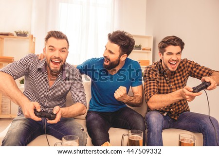 Men\'s contest! excited happy cheerful man play video game with his friends