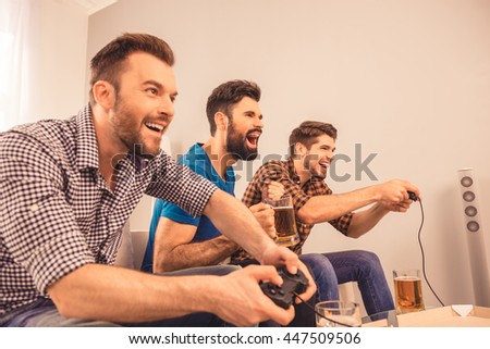 at home excited happy cheerful men play video game with joystick