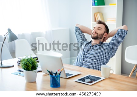 Young worker having break and resting after solving task