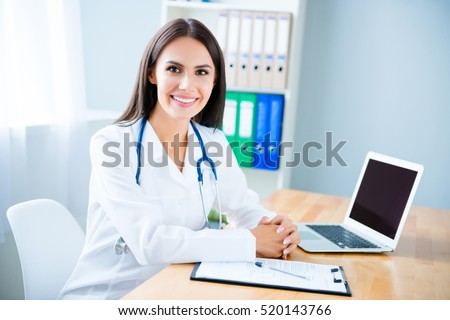 Portrait of cheerful happy female doctor on consultation