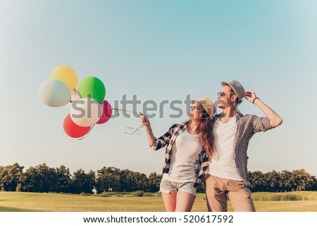 couple in love walking with balloons