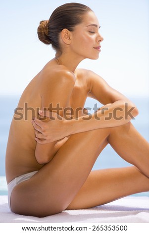 Young woman sitting bare cheated.