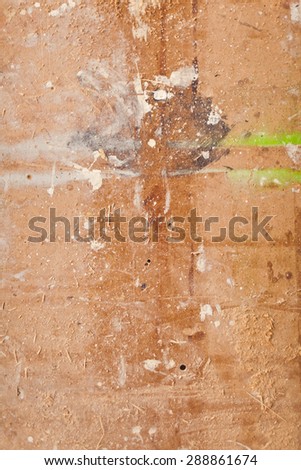 Close-up view of multicolored paint stains on a brown wooden deck backdrop vertical oriented look