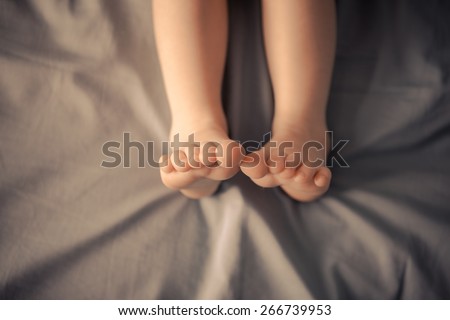 Little feet in bed. Little feet in bed. Unusual color toning