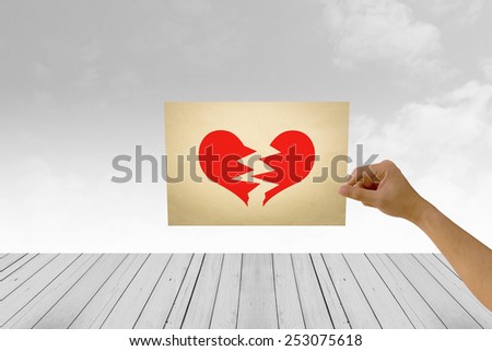 paper in man hand in heartbroken on natural background There is space for you to add your text.