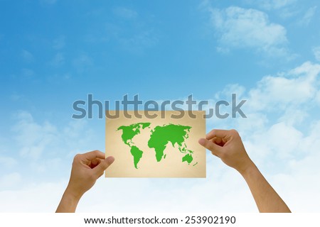 paper in man hand have the world map on natural background There is space for you to add your text.