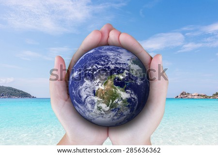 the planet among human hands in concept  Healthy oceans  healthy planet: Elements of this image furnished by NASA