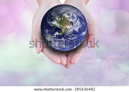 the planet among human hands in concept  Healthy oceans  healthy planet: Elements of this image furnished by NASA