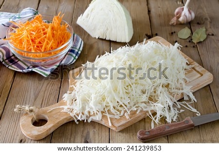 Fresh cabbage prepared for pickling on wood board. Russian tradition