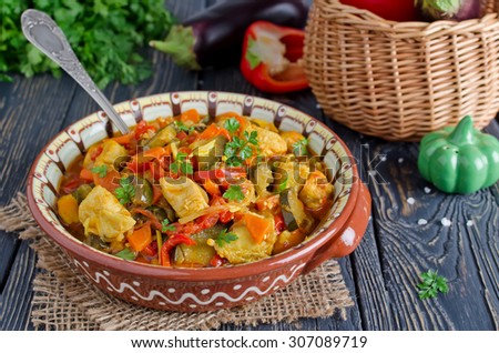 Stew with chicken and vegetables. Chicken with eggplant, bell peppers, carrots and tomatoes