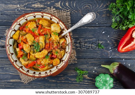 Stew with chicken and vegetables. Chicken with eggplant, bell peppers, carrots and tomatoes