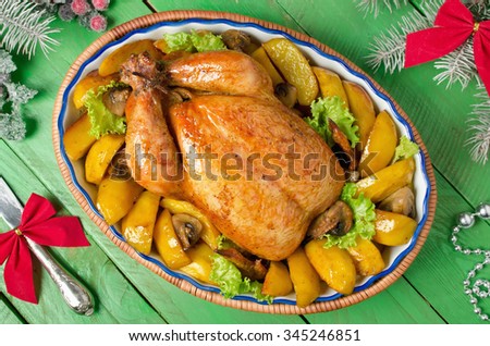 Christmas whole roasted chicken stuffed with mushrooms and baked with potatoes and mushrooms