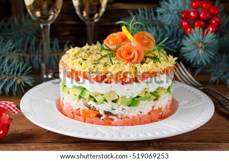 Layered salad with salmon, avocado and cream cheese. Salad for the holiday table