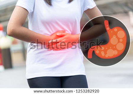 Close up of body woman Suffering from stomach painful or Acid Reflux or Heartburn,Gas,Bloating,Belching and flatulence or gastrointestinal system disease. people,medical and health insurance concept