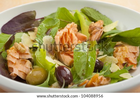 Wood smoked salmon flaked into a salad of lettuce leaves, olives, parmesan and balsamic dressing.