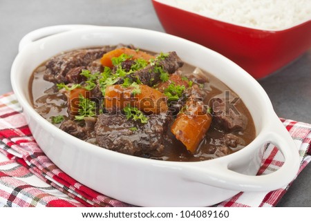 A French stew, daube of beef Provencal has a delicious sauce made from red wine, stock, cinnamon, cloves, orange and herbs. Here it is served with rice.