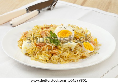 Tasty breakfast dish kedgeree, made with hot smoked salmon, egg, rice, curry powder and onion.