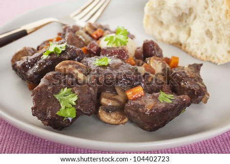 Classic beef bourguignon served with crusty bread. This delicious French meal contains beef, mushrooms, onions, lardons, red wine, stock, vegetables and herbs.