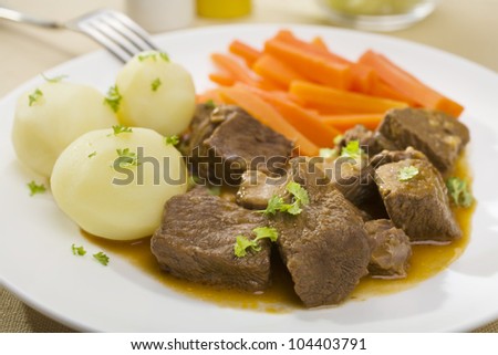 A simple winter dinner of beef casserole with potatoes and carrots.