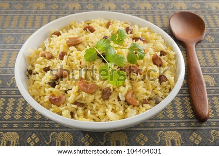 Classic fruit and nut Indian pilau, basmati rice cooked with stock, saffron, garlic, onion, cinnamon, cardamom, sultanas and garnished with cashew nuts and coriander.