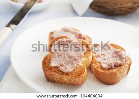Three pieces of toasted baguette spread with Ardennes pate.