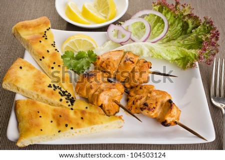 Tandoori chicken with naan bread and salad.