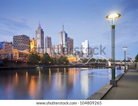Melbourne skyline early on a summer evening, just as the lights start to come on, reflecting in the Yarra River.