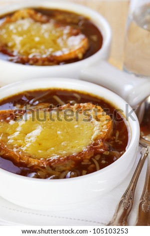 Famous French dish, French onion soup. Caramelised onions cooked in stock with wine and herbs, topped with toasted baguette and cheese and finished under the grill.