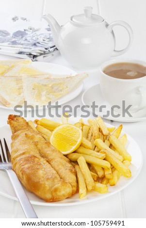 Fish and chips served with buttered bread and a pot of tea. Favourite British seaside supper.
