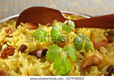 Classic fruit and nut Indian pilau, basmati rice cooked with stock, saffron, garlic, onion, cinnamon, cardamom, sultanas and garnished with cashew nuts and coriander.