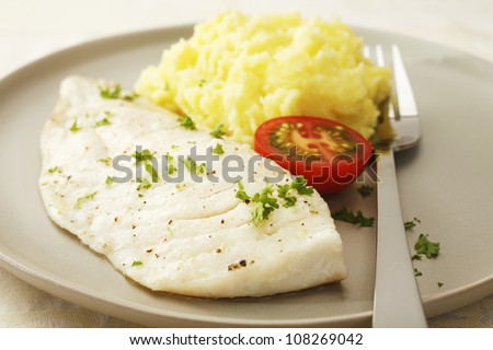 A simple, healthy meal of fish cooked with olive oil and herbs in the microwave, and mashed potato.