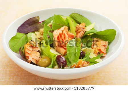 Wood smoked salmon flaked into a salad of lettuce leaves, olives, parmesan and balsamic dressing.