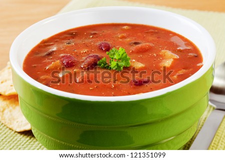 A thick and hearty spicy Mexican soup, this has kidney beans, pinto beans, black beans, tomatoes, potatoes, green peppers, onions,  stock and Mexican spices.