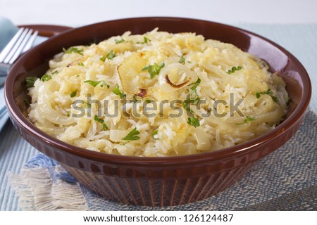 A delicious basmati rice casserole, with buttery onions and gruyere cheese, can be eaten with meat or as a main course with salad.