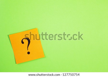 Orange question mark on green background with a lot of copy space. Got a question?