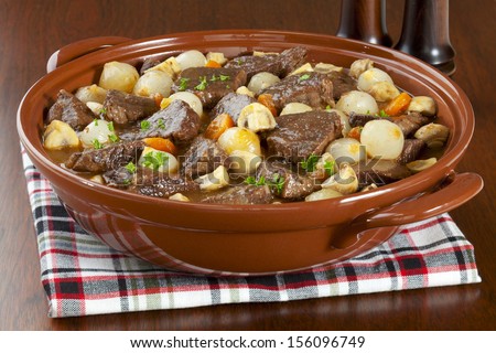 Famous French stew, beef bourguignonne, beef cooked in red wine with onions, mushrooms, bacon and carrots.
