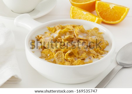 Cornflakes with Milk - a bowl of cornflakes with milk in a light bright setting.