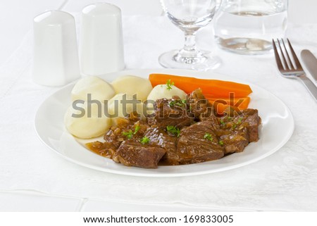 Beef Stew - a plate of simple beef stew with boiled potatoes and carrots.