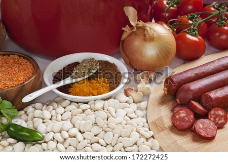 Ingredients for Spanish Chorizo Soup, with butter beans, lentils, parsley, chilli, turmeric, cumin, oregano, garlic, onion, tomatoes and chorizo.
