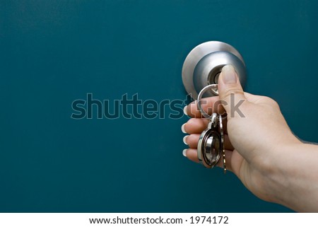 Woman's hand unlocking a door and copy space