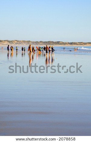 Diverse group of people seen from a distance at Cable Beach, Broome, Western Australia. Group includes Aboriginals, Europeans, old, young, fat and thin.