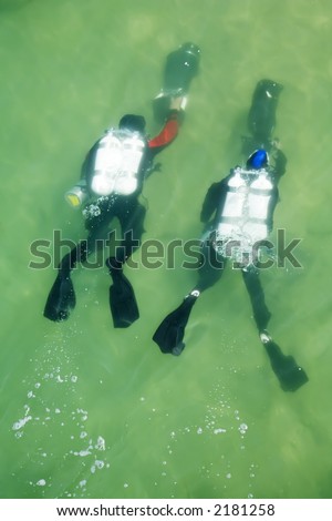 Two divers, underwater with scuba scooters or diver propulsion vehicle